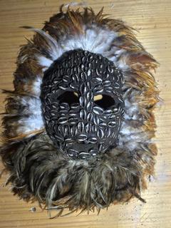 African turtle mask with chicken feathers